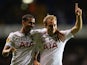 Tottenham's Christian Eriksen celebrates with team mate Kyle Naughton after scoring his team's third goal against Tromso IL during their Europa League group match on September 19, 2013