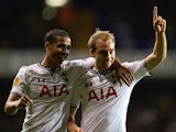 Tottenham's Christian Eriksen celebrates with team mate Kyle Naughton after scoring his team's third goal against Tromso IL during their Europa League group match on September 19, 2013