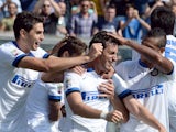 Inter's Diego Alberto Milito is congratulated by teammates after scoring his team's fifth goal against Sassuolo during their Serie A match on September 22, 2013