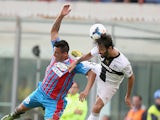 Catania's Fabian Monzon and Parma's Mattia Cassani battle for the ball during their Serie A match on September 22, 2013