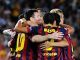 Barcelona's Lionel Messi celebrates with team mates after scoring the his team's fourth goal against Ajax during their Champions League group match on September 18, 2013