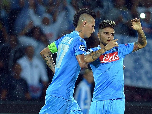 Napoli's Lorenzo Insigne is congratulated by team mate Marek Hamsik after scoring his team's second goal against Dortmund during their Champions League group match on September 18, 2013