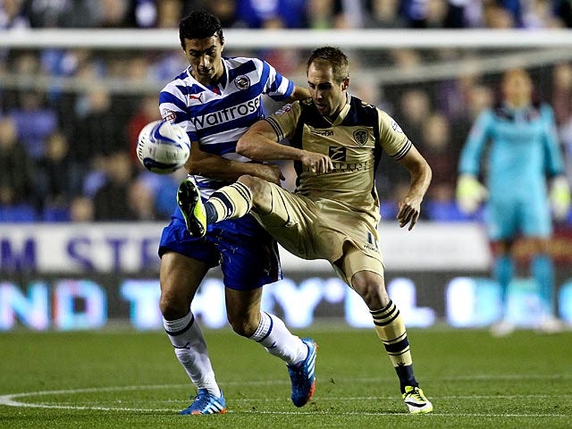 Leeds' Luke Varney and Reading's Stephen Kelly battle for the ball during their Championship match on September 18, 2013