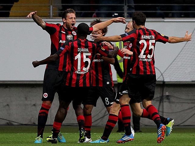 Frankfurt's Marco Russ is congratulated by team mates after scoring his team's second goal against Bordeaux during their Europa League group match on September 19, 2013
