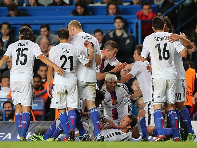Basel's Marco Streller is congratulated by team mates after scoring his team's second goal against Chelsea during their Champions League group match on September 18, 2013