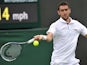 Marin Cilic returns against Marcos Baghdatis on his way to victory in their men's first round match at Wimbledon on June 24, 2013