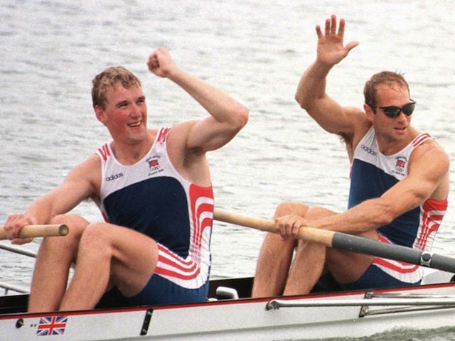 Matthew Pinsent and Steve Redgrave wave to the crowd after winning gold in the coxless pairs at the Atlanta Olympics on July 27, 1996
