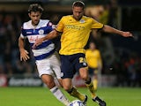 Brighton's Matthew Upson and QPR's Charlie Austin battle for the ball during their Championship match on September 18, 2013