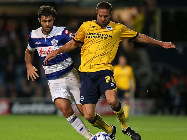 Brighton's Matthew Upson and QPR's Charlie Austin battle for the ball during their Championship match on September 18, 2013