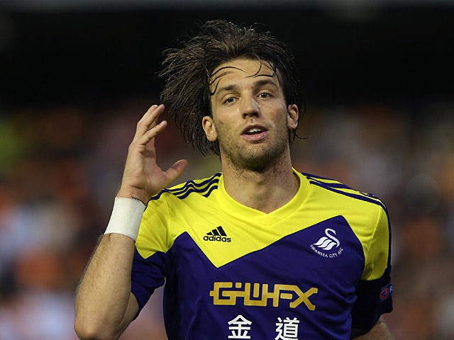 Swansea's Michu celebrates after scoring his team's second goal against Valencia during their Europa League group match on September 19, 2013