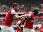 Arsenal's Bacary Sagna is congratulated by teammate Olivier Giroud after scoring his team's third goal against Stoke during their Premier League match on September 22, 2013