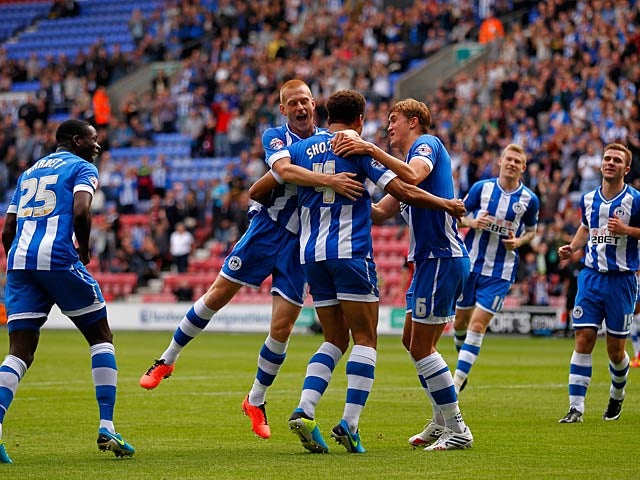 Wigan's Ryan Shotton is congratulated by teammates after scoring the opening goal against Ipswich during their Championship match on September 22, 2013