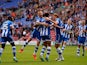 Wigan's Ryan Shotton is congratulated by teammates after scoring the opening goal against Ipswich during their Championship match on September 22, 2013