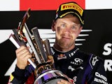 Sebastian Vettel lifts the trophy on the podium after winning the Singapore Formula One Grand Prix on September 22, 2013