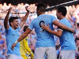 Manchester City's Sergio Aguero celebrates with teammates Alvaro Negredo and Samir Nasri after scoring his team's third goal against Manchester United during their Premier League match on September 22, 2013