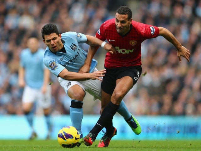 Sergio Aguero and Rio Ferdinand contest possession in the Manchester derby.