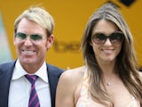 Elizabeth Hurley and Shane Warne attend the Betfair Weekend King George Day and Summer Garden Party at Ascot Racecourse on July 27, 2013 