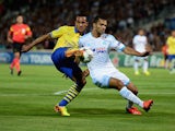 Arsenal's Theo Walcott and Marseille's Jeromy Morel battle for the ball during their Champions League group match on September 18, 2013