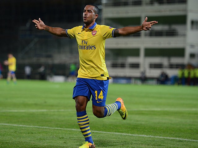Arsenal's Theo Walcott celebrates after scoring the opening goal against Marseille during the Champions League on September 18, 2013