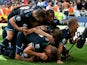Spurs players pile on top of Paulinho following his last minute winner against Cardiff City on September 22, 2013