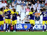 Swansea's Wilfried Bony celebrates with team mates after scoring the opening goal against Valencia during their Europa League group match on September 19, 2013
