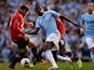 Manchester United's Wayne Rooney and Manchester City's Yaya Toure battle for the ball during their Premier League match on September 22, 2013
