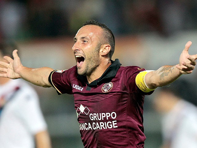 Livorno's Andrea Luci celebrates after scoring the opening goal against Cagliari during their Serie A match on September 25, 2013