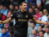 Manchester City player Edin Dzeko celebrates after scoring the second goal during the Barclays Premier League match between Aston Villa and Manchester City at Villa Park on September 28, 2013