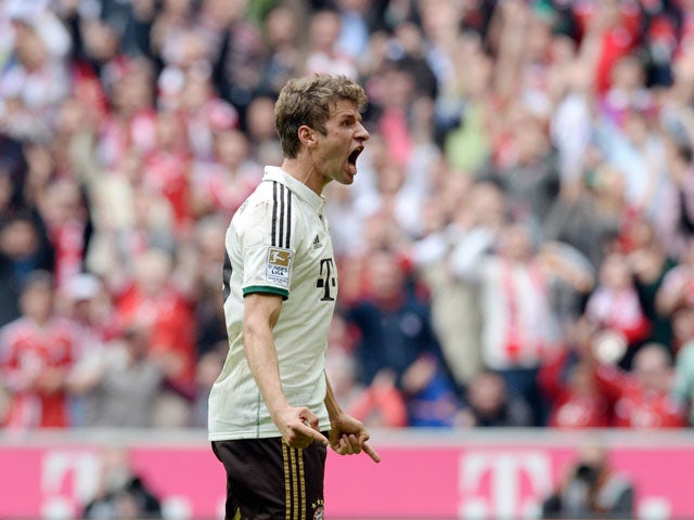 Bayern Munich's striker Thomas Muller celebrates after the first goal for Munich during the German first division Bundesliga football match Bayern Muenchen v VfL Wolfsburg in Munich, Germany, on September 28, 2013