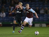 Burnley'a Ben Mee and Forest's Dan Harding battle for the ball during their League Cup match on September 24, 2013