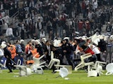 Besiktas football team supporters fight with Anti riot police officers during the Turkish super league football match Besiktas vs Galatasaray on September 22, 2013