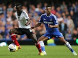 Buomesca Tue Na Bangna of Fulham looks to turn Ashley Cole of Chelsea during the Barclays Premier League match between Chelsea and Fulham at Stamford Bridge on September 21, 2013