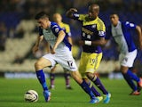 Birmingham's Callum Reilly and Swansea's Dwight Tiendalli battle for the ball during their League Cup match on September 25, 2013