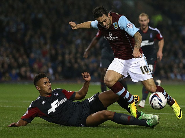 Burnley's Danny Ings and Nottingham Forest's Jamaal Lascelles battle for the ball during their League Cup match on September 24, 2013