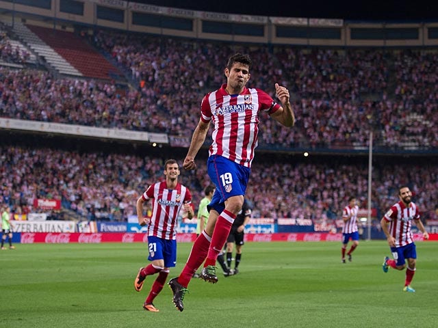 Atletico Madrid's Diego Costa celebrates after scoring his second goal against Osasuna during their La Liga match on September 24, 2013