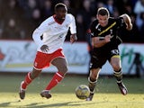 Don Cowan of Stevenage in action with Ryan Nelsen of Tottenham during the FA Cup Fifth Round match between Stevenage and Tottenham Hotspur at The Lamex Stadium on February 19, 2012