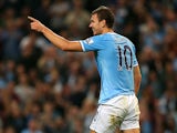 Man City's Edin Dzeko celebrates after scoring the opening goal against Wigan during their League Cup match on September 24, 2013