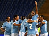 Lazio's Honorato Ederson is congratulated by teammates after scoring the opening goal against Catania during their Serie A match on September 25, 2013