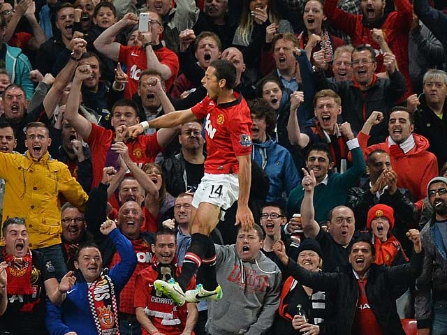 Man United's Javier Hernandez celebrates in front of fans after scoring the opening goal against Liverpool during their League Cup match on September 25, 2013