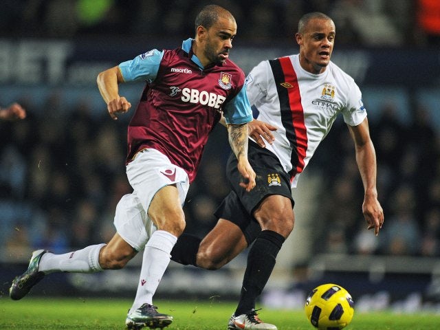 Kieron Dyer attempts to beat Vincent Kompany in December 2010.