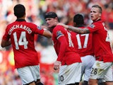 Wayne Rooney of Manchester United celebrates with team mates after scoring the Barclays Premier League match between Manchester United and West Bromwich Albion at Old Trafford on September 28, 2013 