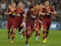 Roma's Mehdi Amine Benatia celebrates with teammates after scoring the opening goal against Sampdoria during their Serie A match on September 25, 2013