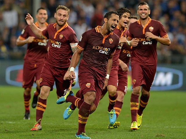 Roma's Mehdi Amine Benatia celebrates with teammates after scoring the opening goal against Sampdoria during their Serie A match on September 25, 2013