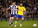 West Brom's Graham Dorrans and Arsenal's Mikel Arteta battle for the ball during their League Cup match on September 25, 2013