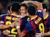 Barcelona's Neymar is congratulated by teammates after scoring the opening goal against Real Sociedad during their La Liga match on September 24, 2013