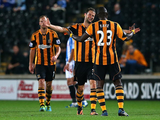 Hull's Nick Proschwitz celebrates with teammate Abdoulaye Diagne-Faye after scoring the opening goal against Huddersfield during their League Cup match on September 24, 2013
