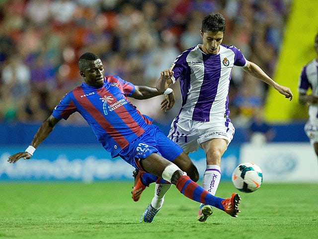 Real Valladolid's Omar Ramos and Levante's Papa Diop battle for the ball during their La Liga match on September 24, 2013
