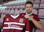 New Northampton Town signing Paul Reid poses with a shirt during a photo call at Sixfields Stadium on September 27, 2013