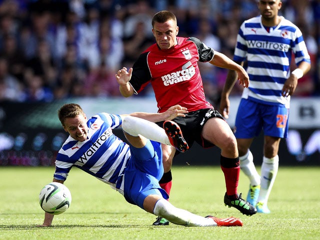 Paul Taylor of Ipswich battles with Chris Gunter of Reading during the Sky Bet Championship match between Reading and Ipswich Town at the Madejski Stadium on August 03, 2013