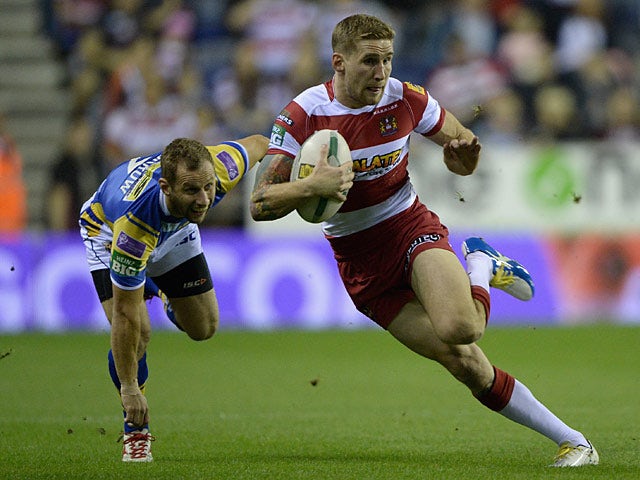 Wigan's Sam Tomkins gets past Leed's Rob Burrow during their Super League qualifying semi-final match on September 27, 2013